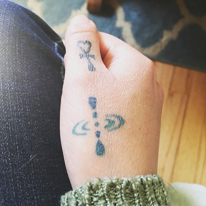 Mindfulness symbol tattoo on a hand