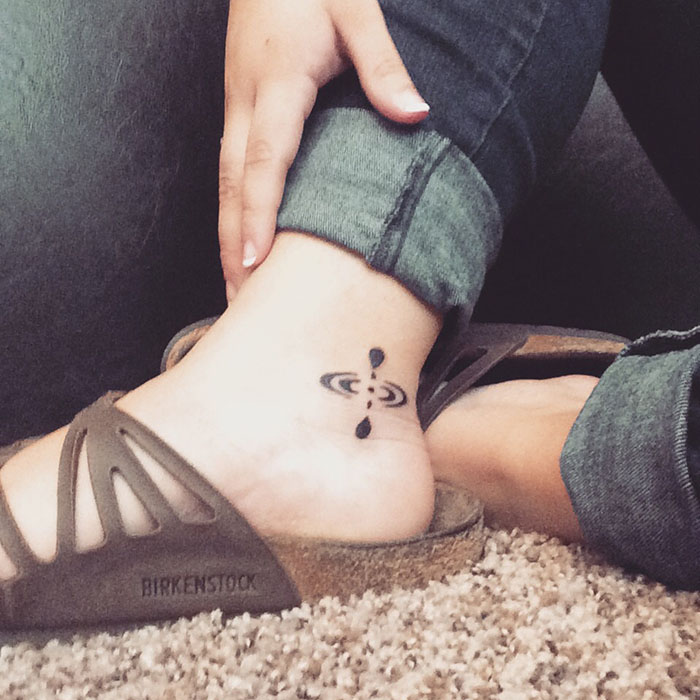 Mindfulness tattoo on an ankle