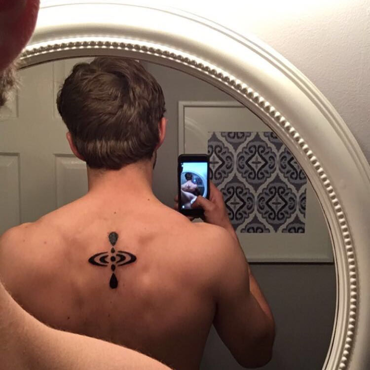 Mindfulness tattoo on the back