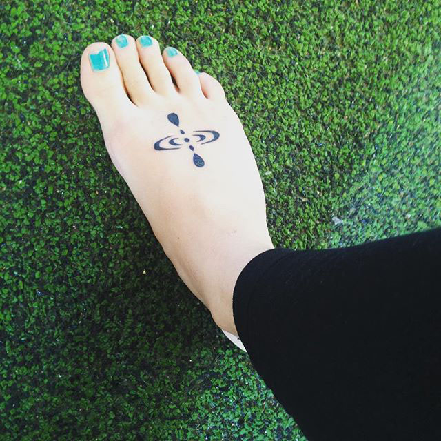 Mindfulness tattoo on a foot